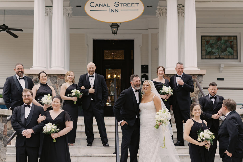 Wedding party celebrating on the front steps of Canal Street Inn in New Orleans