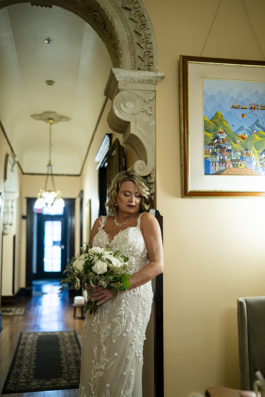 Bride inside the historic Canal Street Inn holding her bouquet