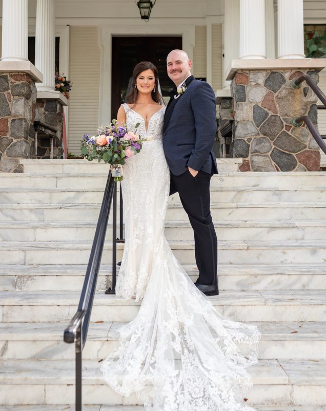 Bride and groom on the steps of Canal Street Inn during a New Orleans destination wedding